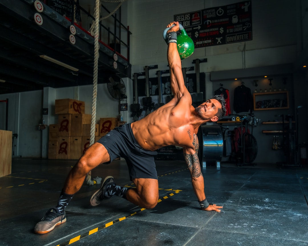 A collection of recovery tools including foam rollers, massage balls, and resistance bands on a gym floor.