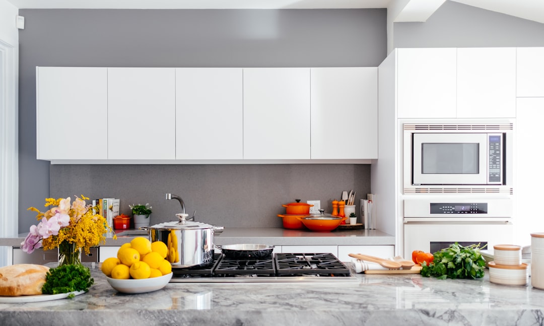 A collection of essential kitchen tools and appliances arranged neatly on a countertop, showcasing items like a cutting board, knives, measuring cups, and a blender.