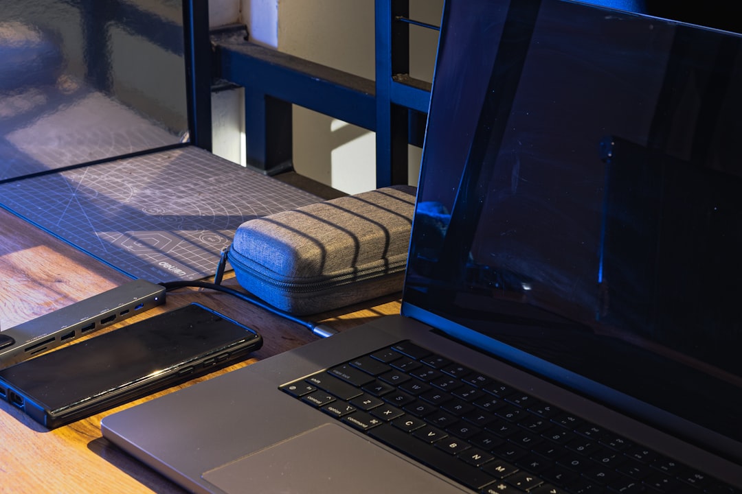 A modern workspace featuring various tech accessories like a laptop, headphones, and smart devices on a clean desk.